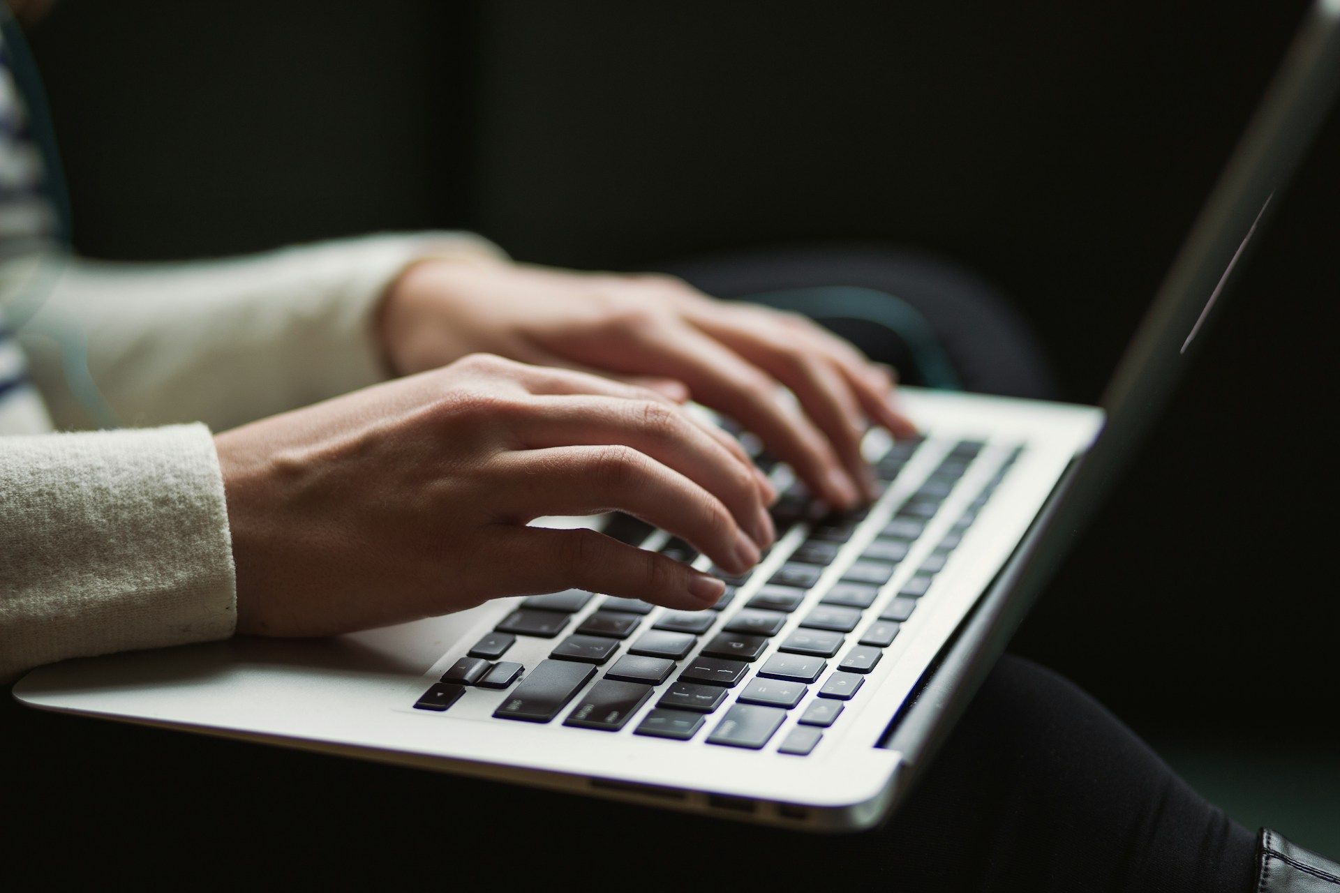 A girl typing on macbook