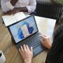 Woman using MacBook and Windows 10