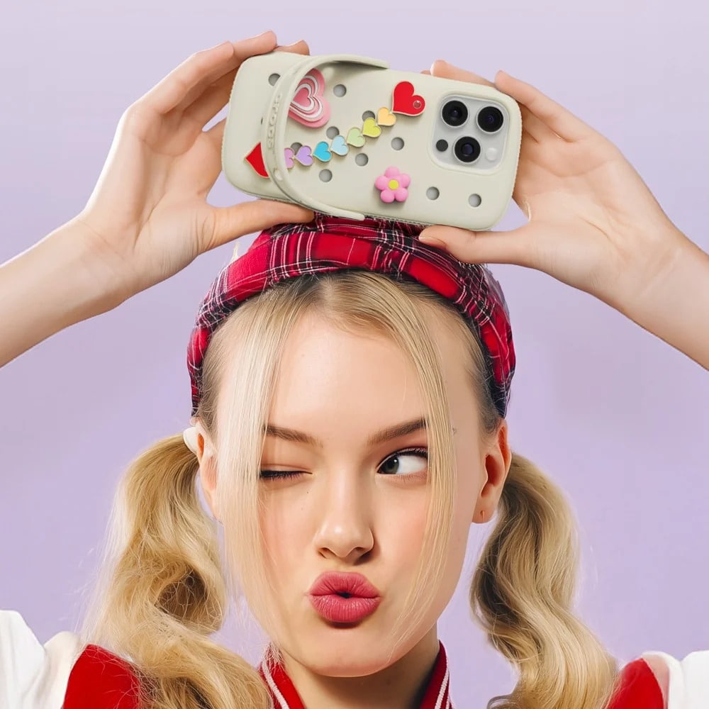 A girl holding Crocs smartphone in case