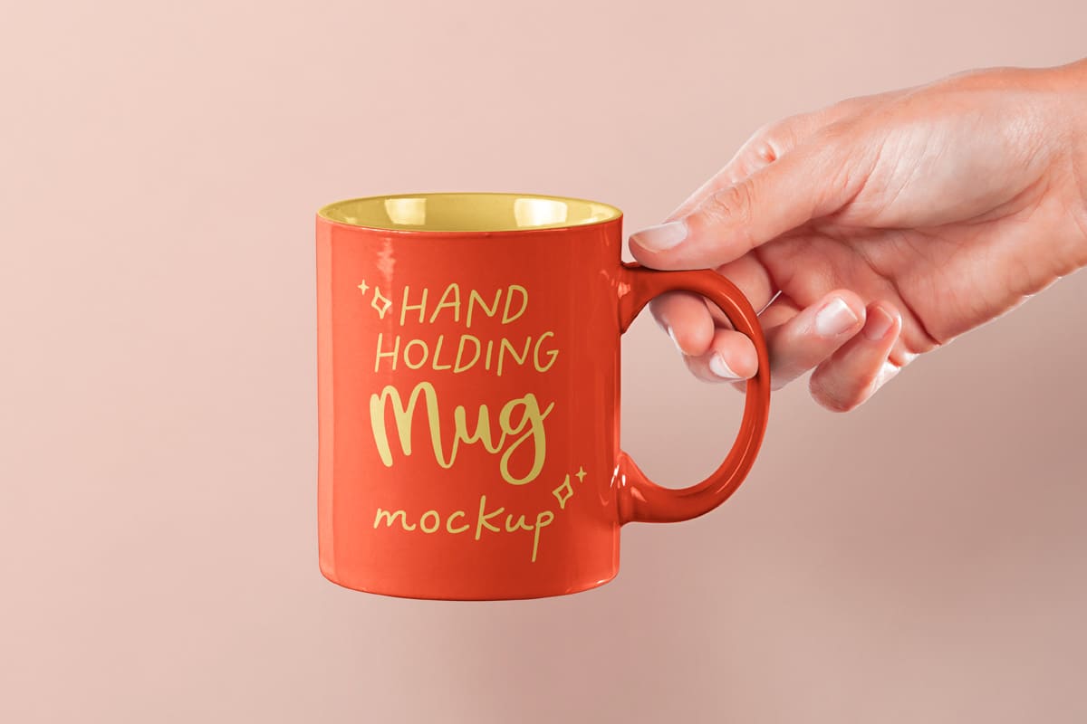 A free hand holding mug mockup