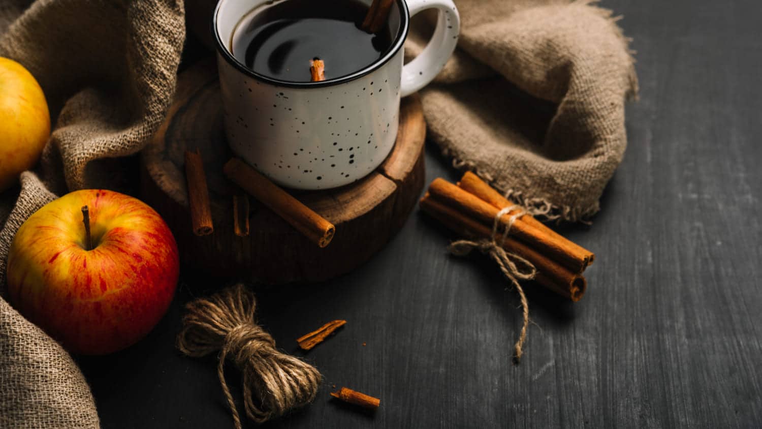 A spicy hot red wine, apple on the black table