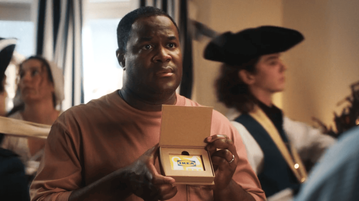 Man giving an IKEA gift card to his wife