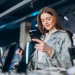 Apple is preparing an unusually large iOS 26.4 update Apple store girl trying iPhone